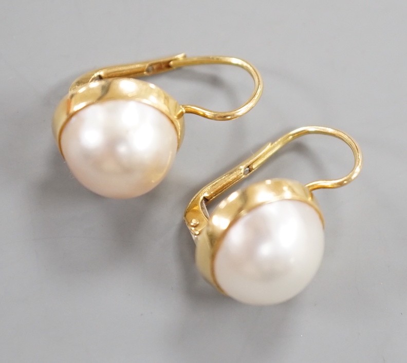 A modern pair of Italian 750 yellow metal and mabe pearl set earrings, diameter 11mm, gross weight 6.4 grams.